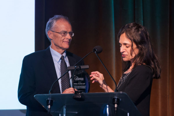 MFJ Executive Director Jeanette Zelhof presents MFJ Board Member Jim Arden with pro bono award recognizing Sidley Austin LLP